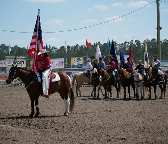Pro Rodeo Contestant Holding Flag